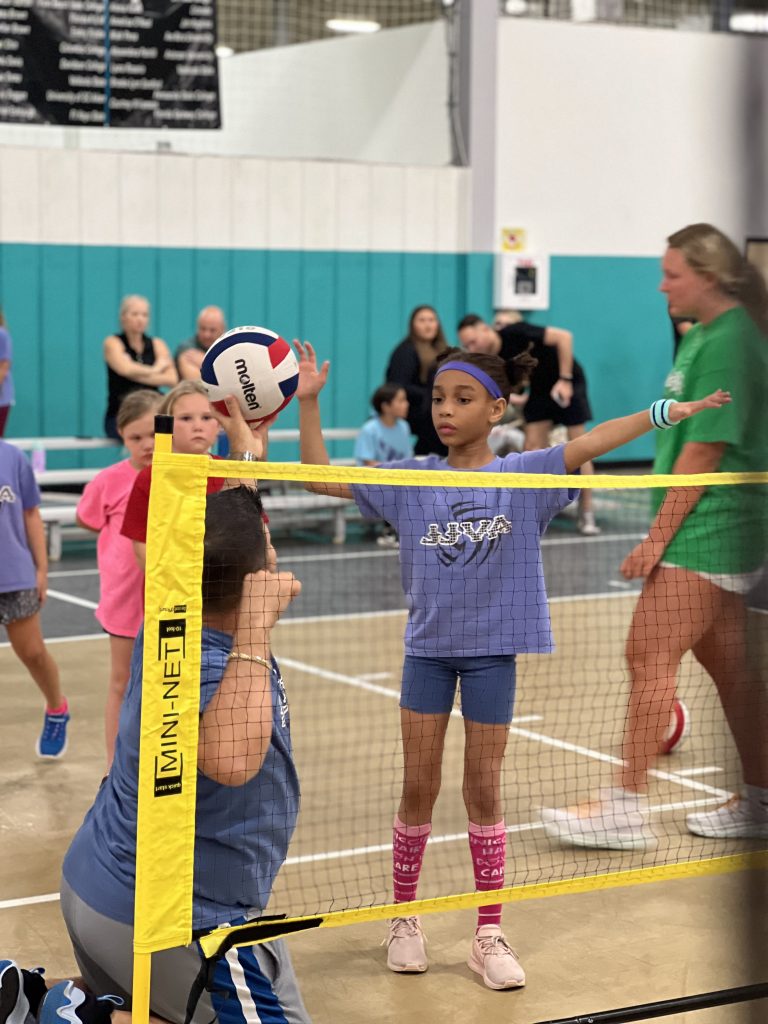 Young Female Volleyball Player Learning Serving form at JJVA
